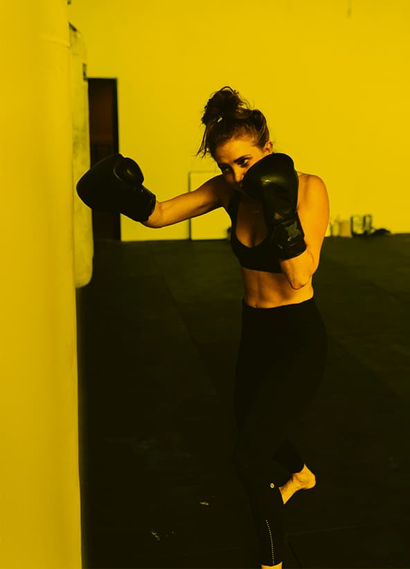 Woman training on punching bag