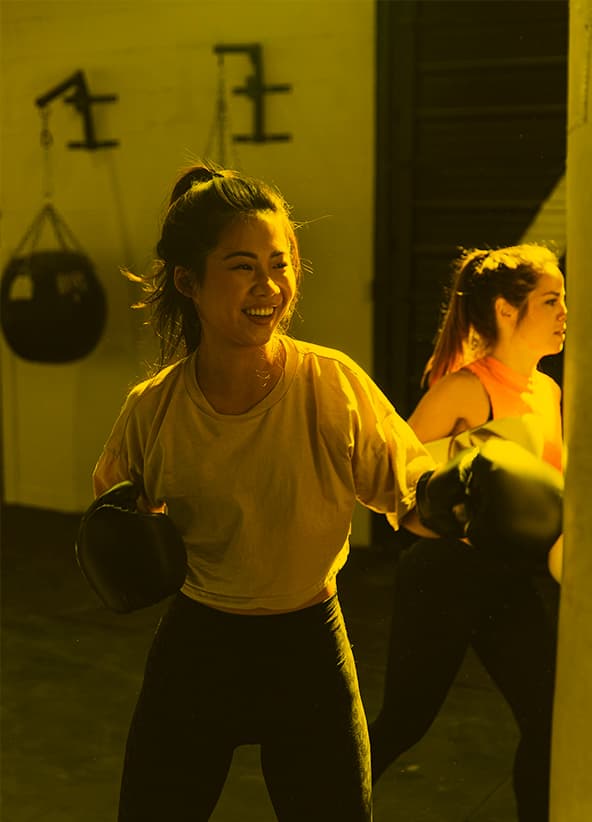 Women training on punching bags